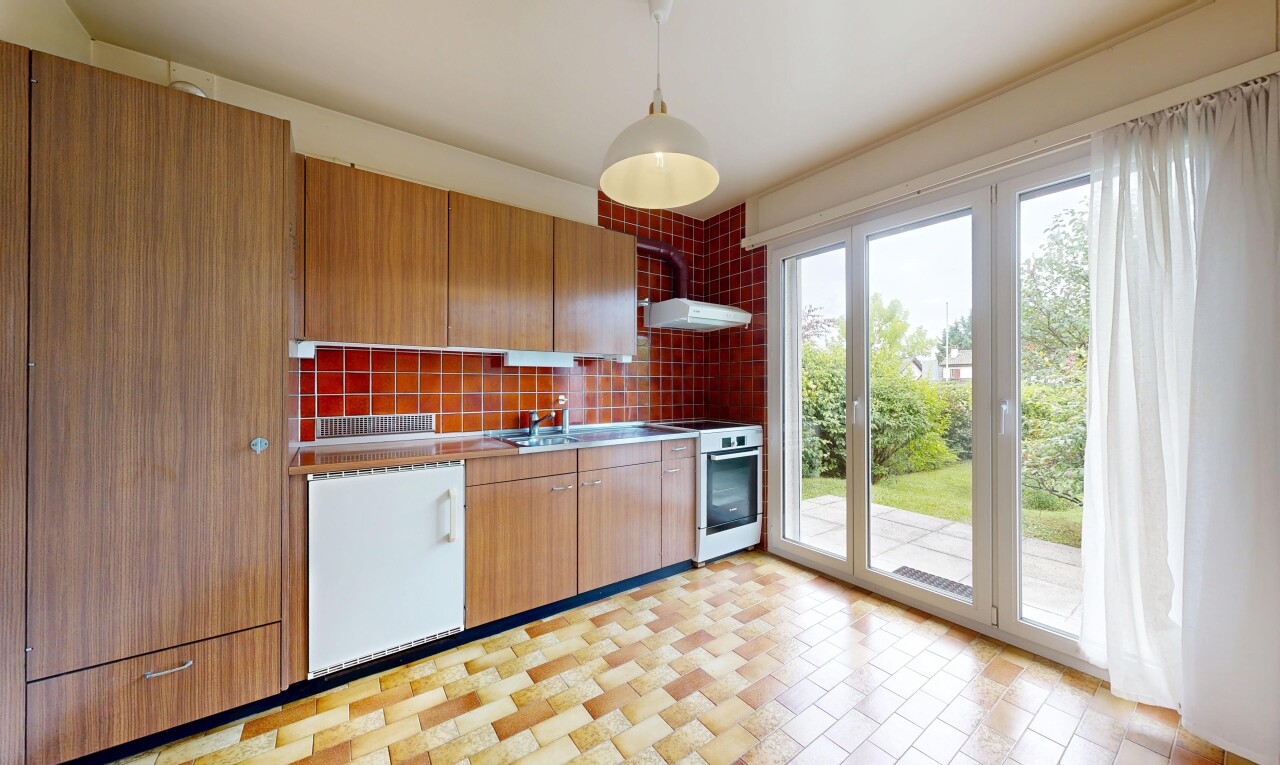 kitchen featuring range with gas cooktop, decorative light fixtures, backsplash, range hood, and wood finish cabinets