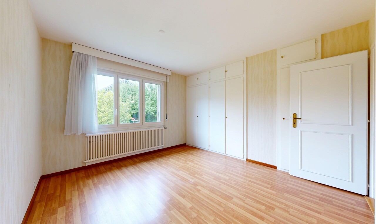 spare room with radiator heating unit and light wood finished floors