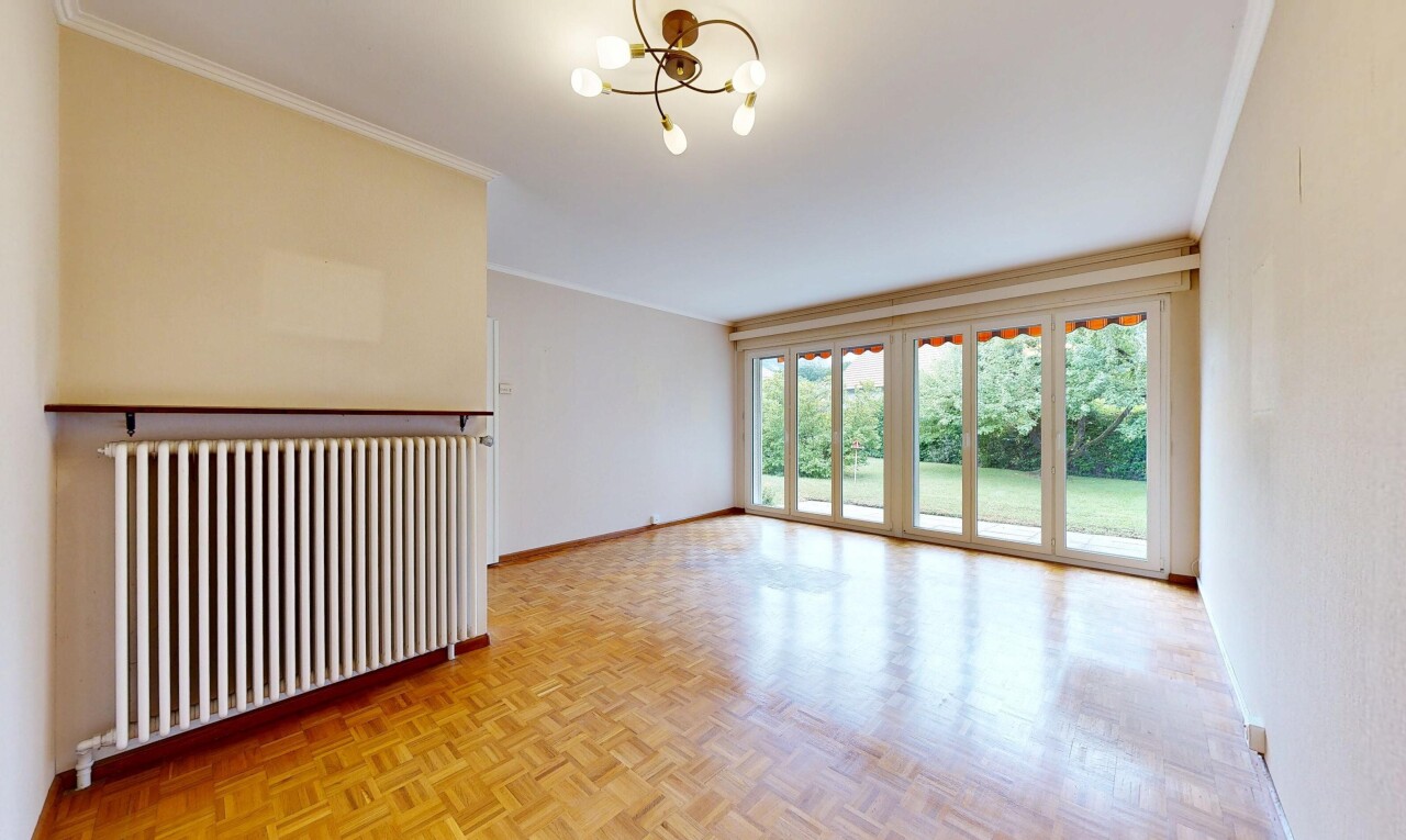 spare room with parquet floors, hanging lights, radiator heating unit, and ornamental molding