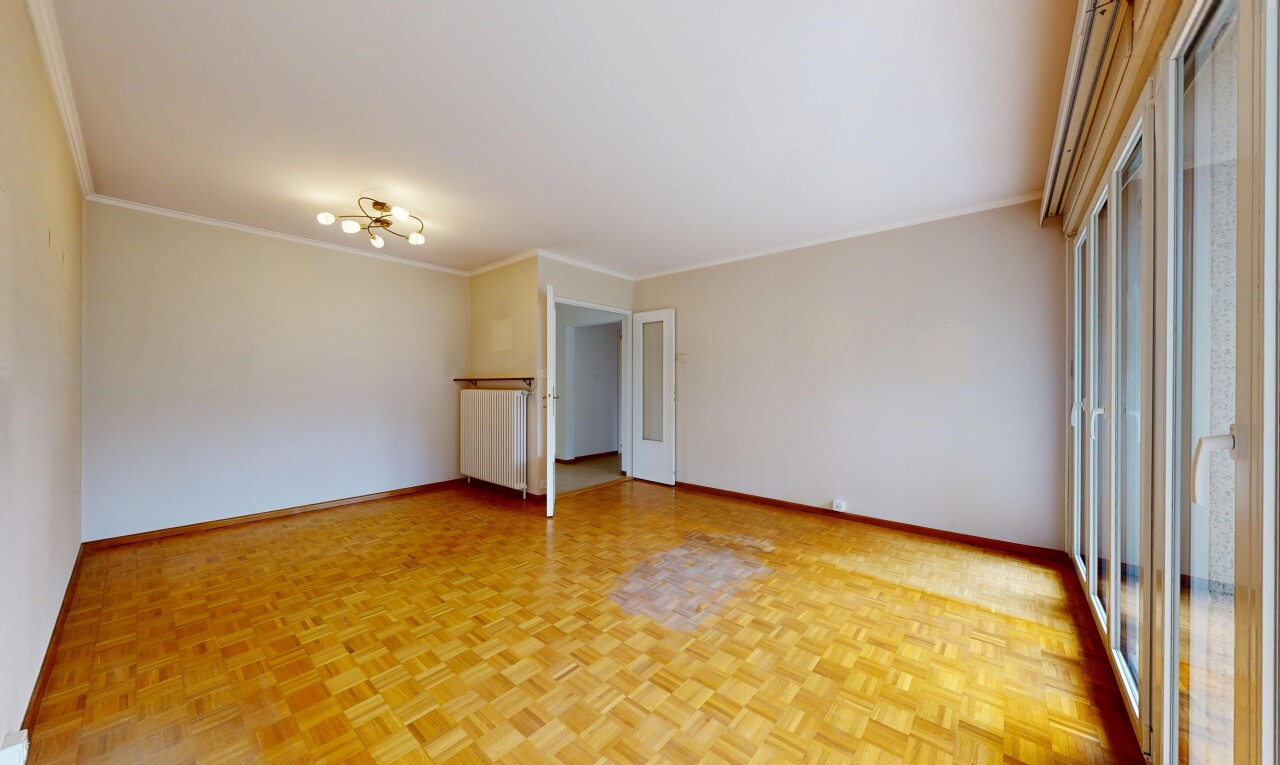 unfurnished room featuring parquet floors, radiator, and ornamental molding