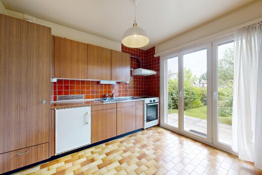 kitchen featuring range with gas cooktop, decorative light fixtures, backsplash, range hood, and wood finish cabinets