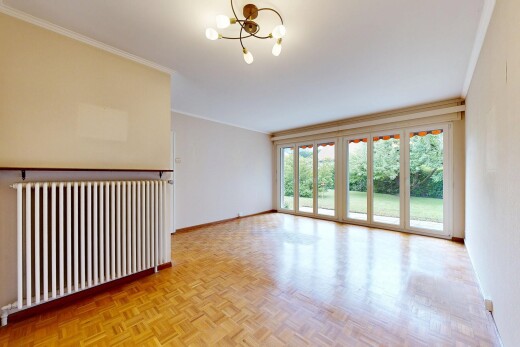 spare room with parquet floors, hanging lights, radiator heating unit, and ornamental molding