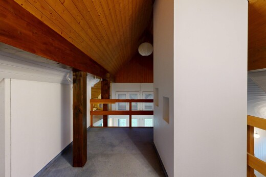 hallway with wood ceiling, vaulted ceiling, and carpet