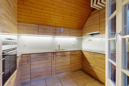 kitchen with stainless steel oven, modern cabinets, light tile patterned flooring, brown cabinetry, and ventilation hood