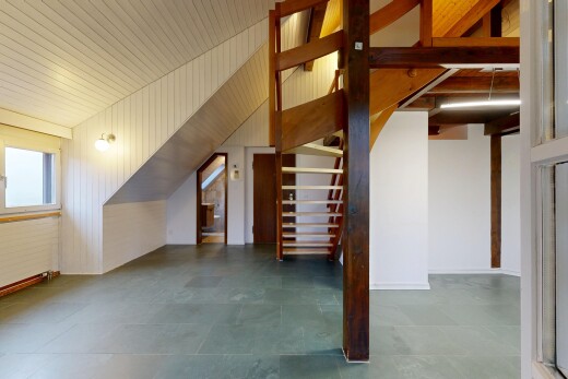 staircase featuring wooden walls