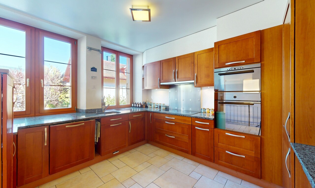 cuisine avec natural light, lumière naturelle, armoires de style shaker, armoires marron moyen, et four double