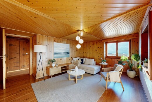 living room featuring wood finished floors, wood ceiling, and wood walls