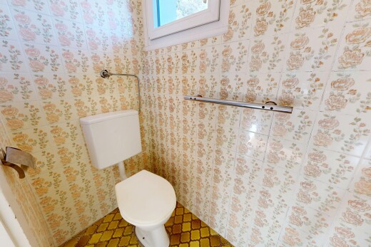 half bathroom featuring toilet and tile patterned floors