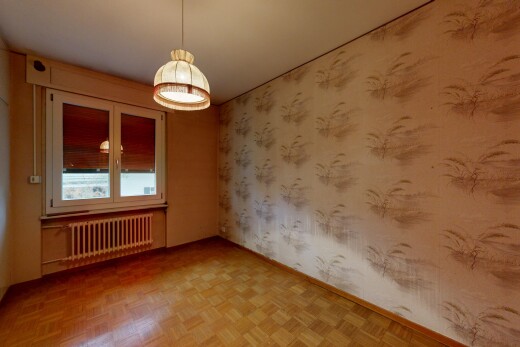 pièce vide avec mur en papier peint, wallpaper wall, parquet floor, radiateur, et lumière naturelle