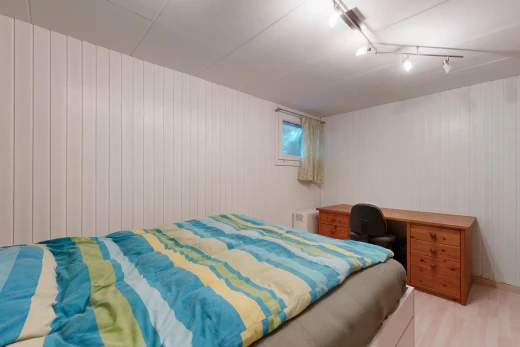 zimmer / schlafzimmer mit natürliches licht, deckenbeleuchtung, bürobereich, holzfußboden, und wood finish floor
