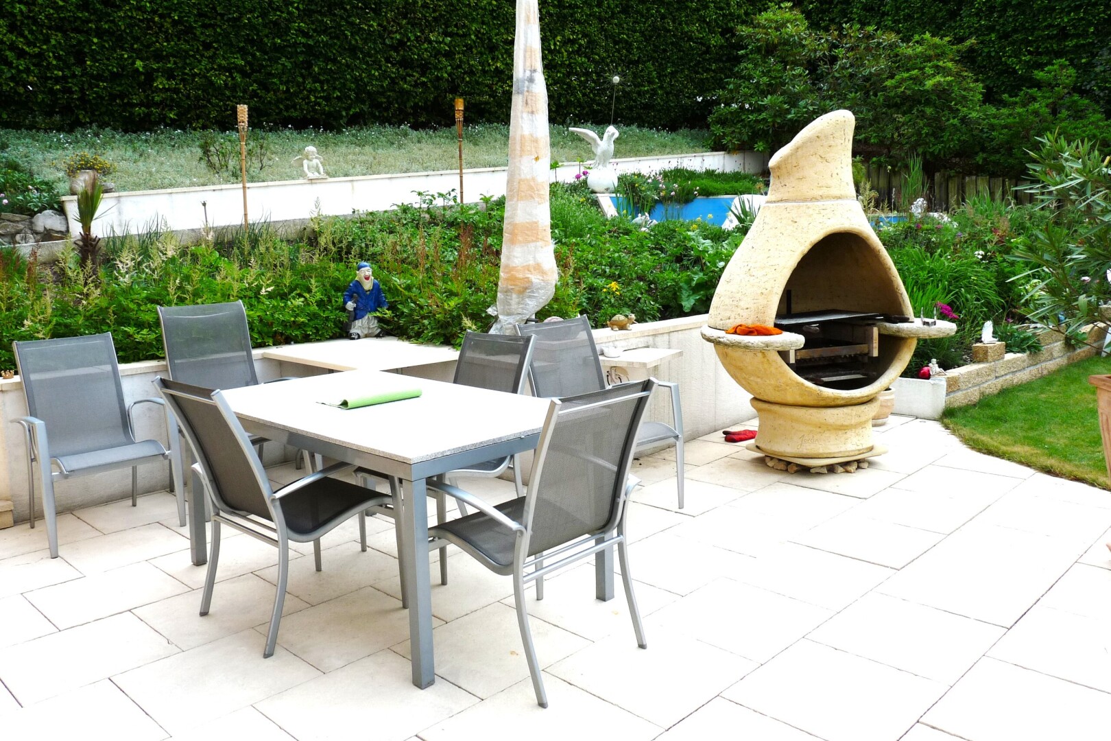 terrace with a patio area, outdoor dining space, and exterior fireplace