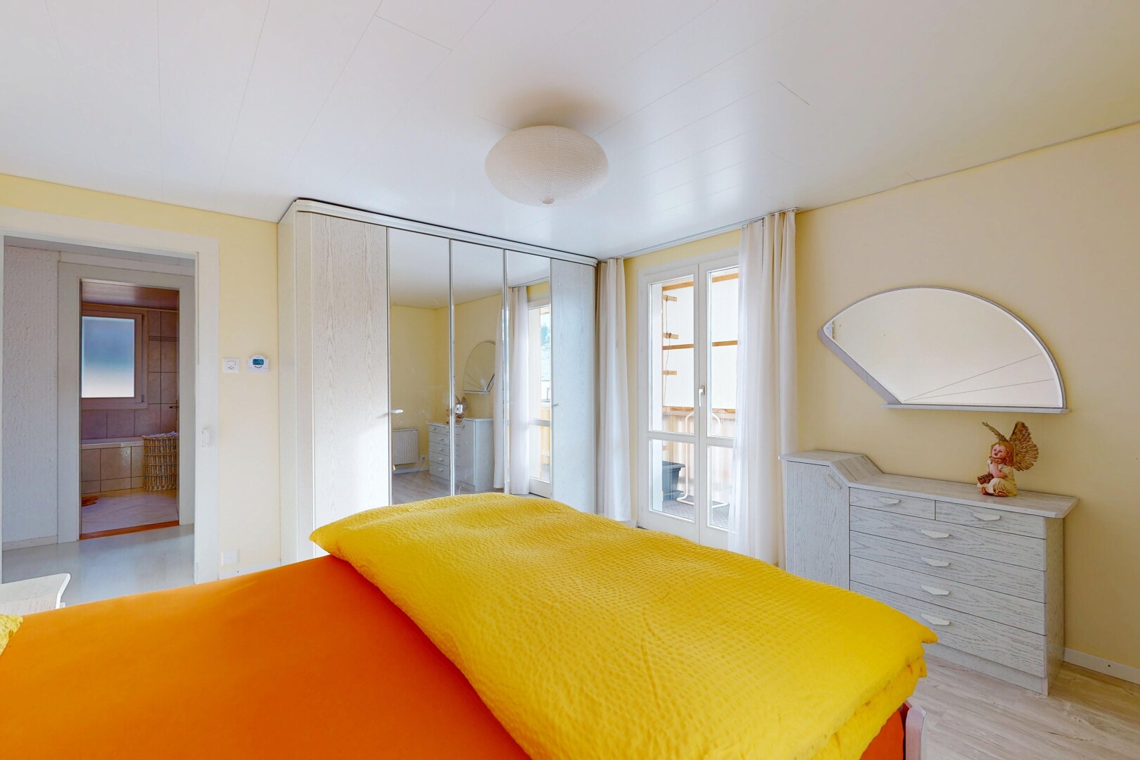 room featuring multiple windows and a closet