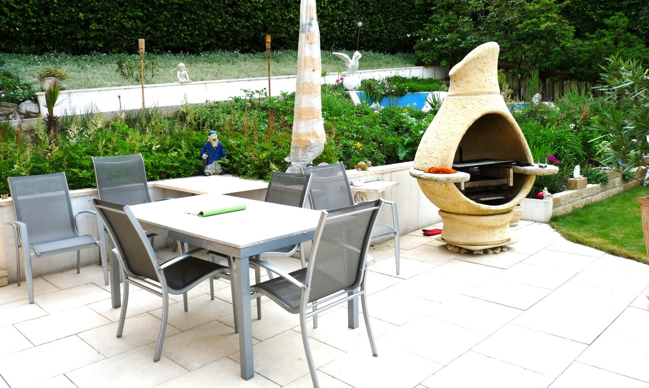 terrace with a patio area, outdoor dining space, and exterior fireplace