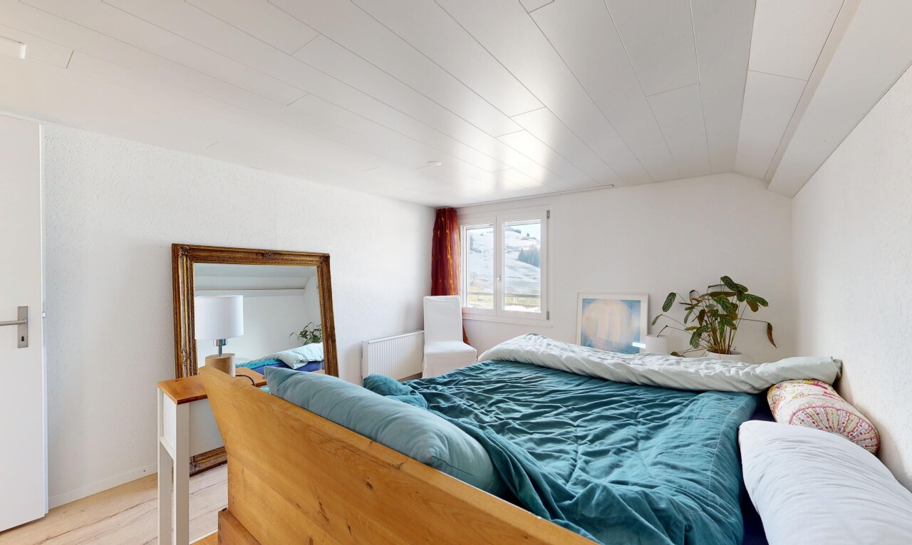room featuring radiator heating unit, light wood finished floors, and vaulted ceiling