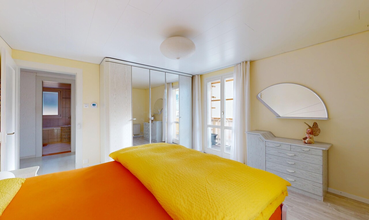 room featuring multiple windows and a closet
