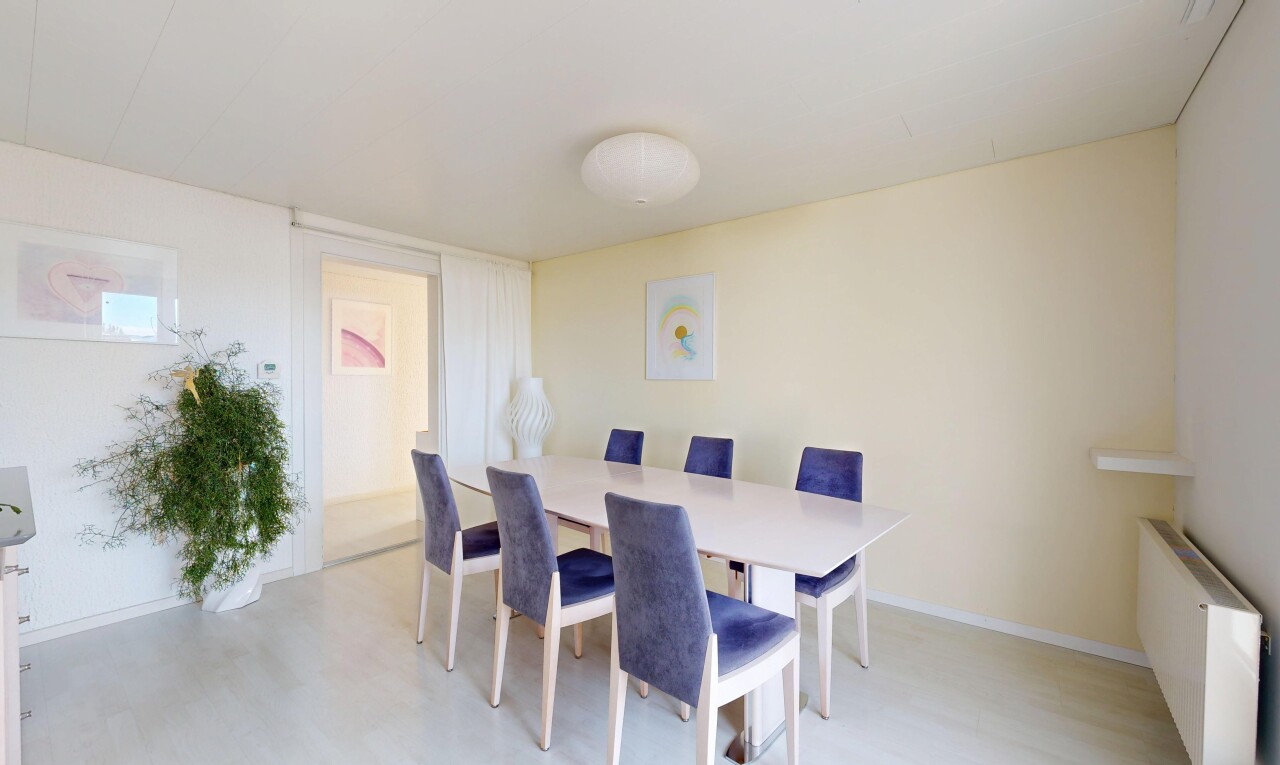 dining space featuring light wood finished floors and baseboards