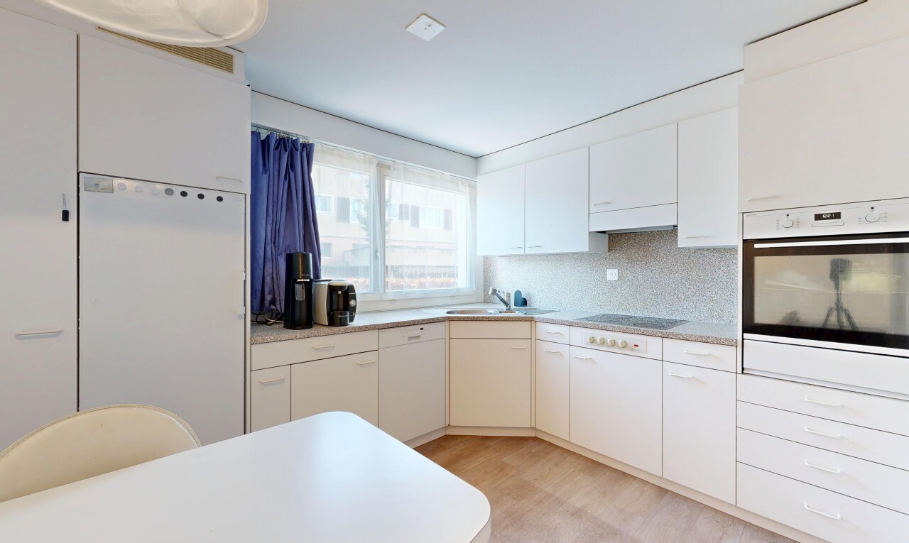 kitchen featuring white fridge, light countertops, stainless steel oven, and decorative backsplash