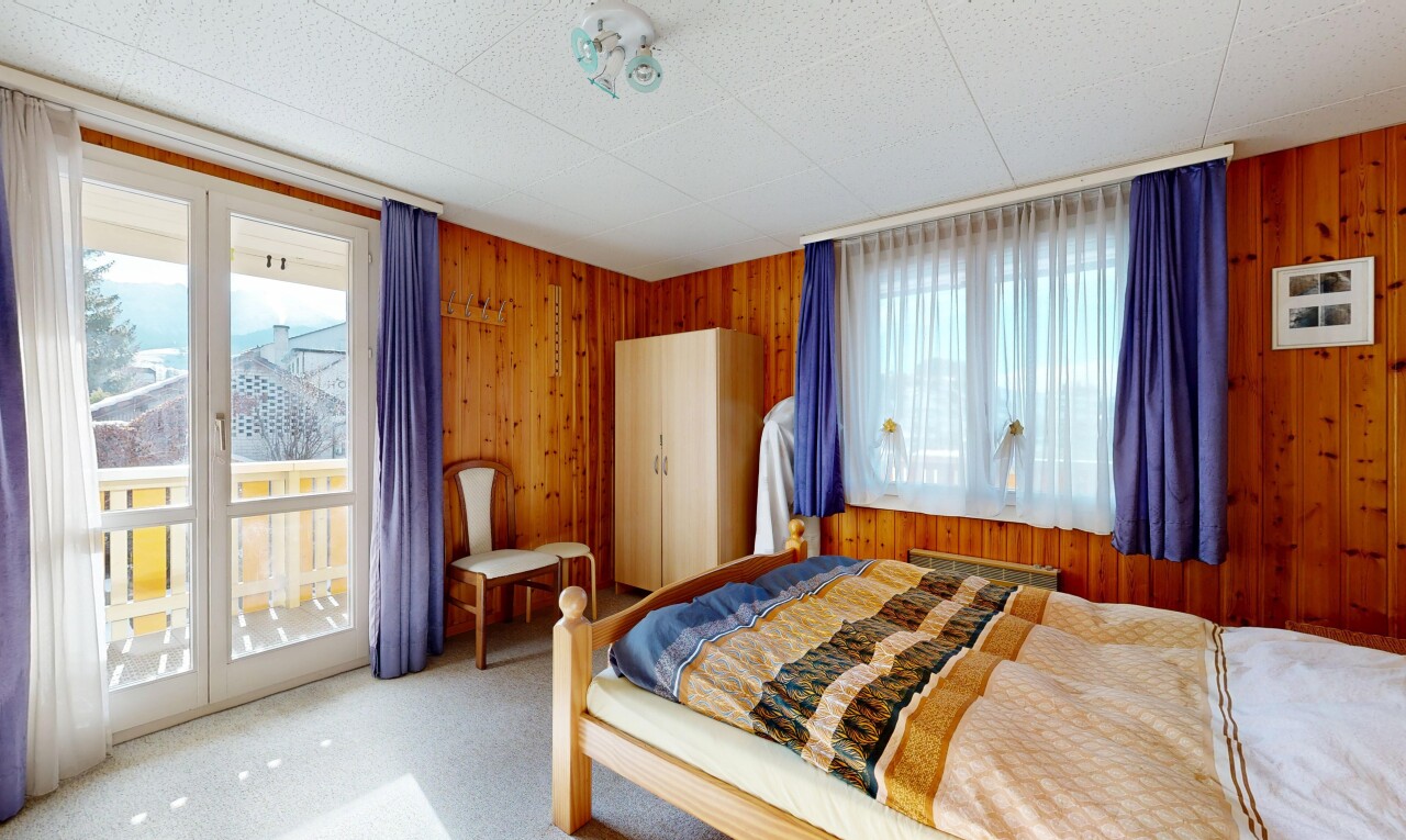 room / bedroom featuring wood walls, access to outside, and carpet floors