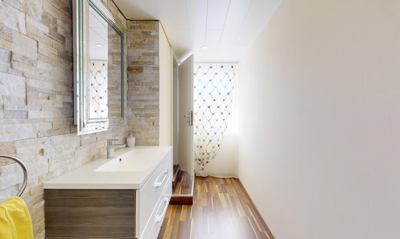 full bathroom with vanity, light wood-style flooring, and a shower