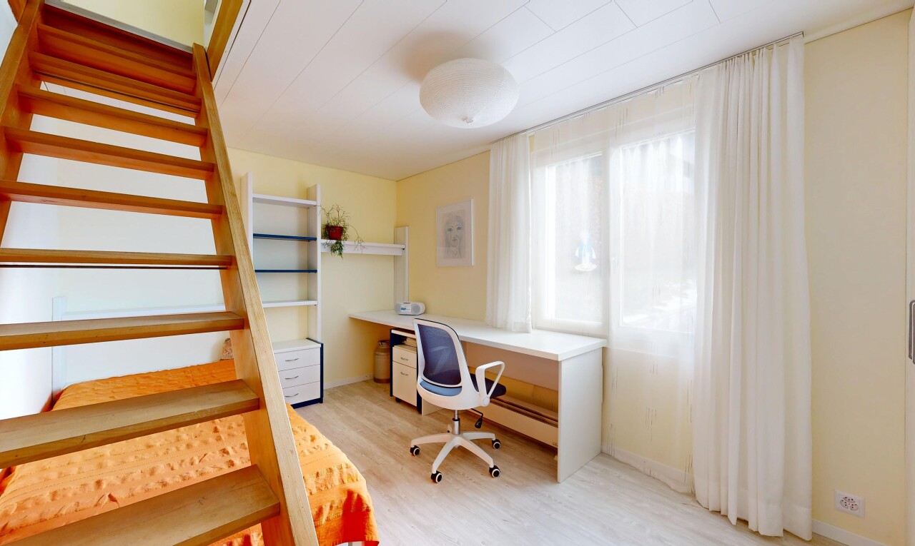 office space featuring light wood-style flooring, baseboard heating, and built in study area