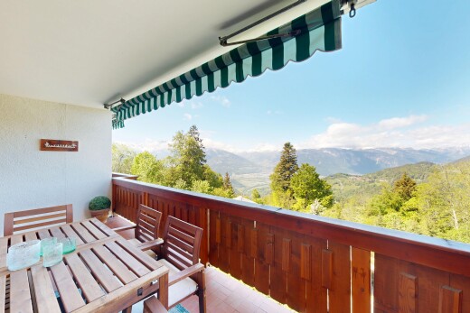 balcony featuring outdoor dining space and a mountain view