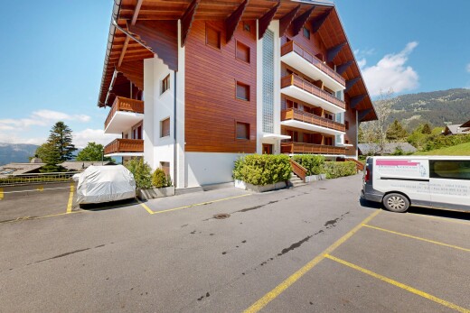 view of apartment building / complex with uncovered parking