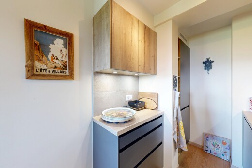 kitchen featuring light wood finished floors, light wood finish cabinetry, modern cabinets, and backsplash