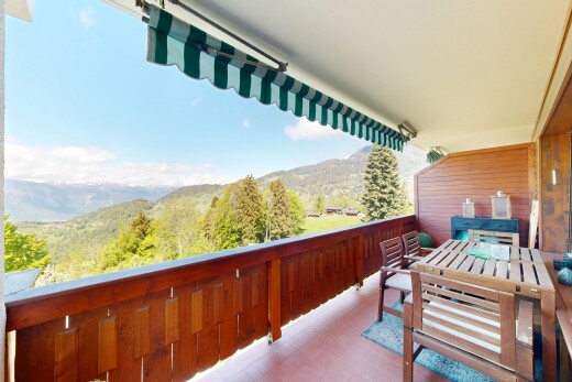 balcony with a mountain view and outdoor dining area