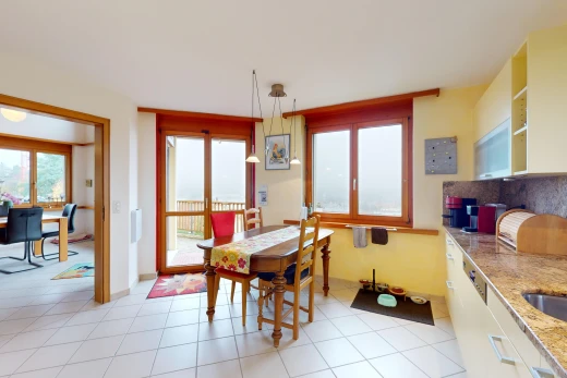 küche mit fliesenboden, pendelleuchte, weiße schränke, und natürliches licht