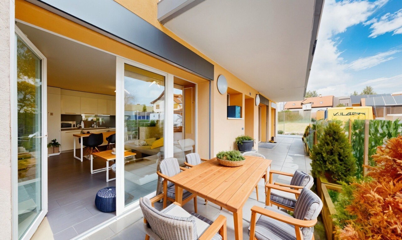 terrace with a balcony and outdoor dining space