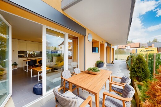 terrace with a balcony and outdoor dining space