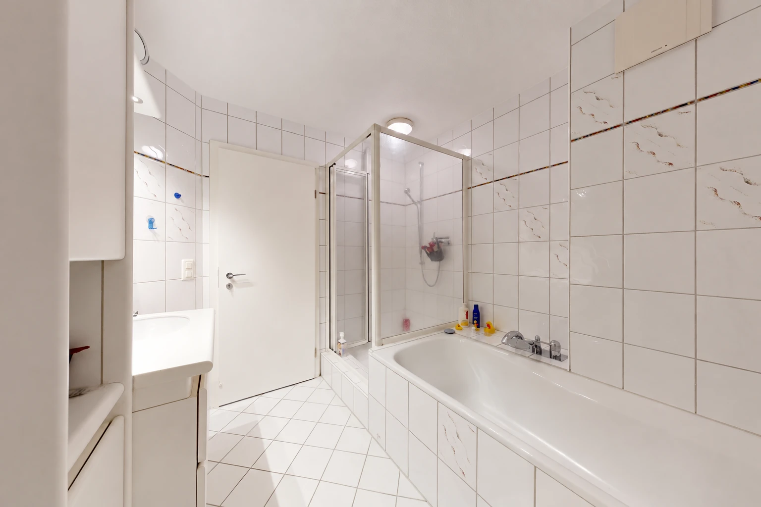 bathroom featuring a shower stall, tile walls, vanity, a bath, and light tile patterned floors
