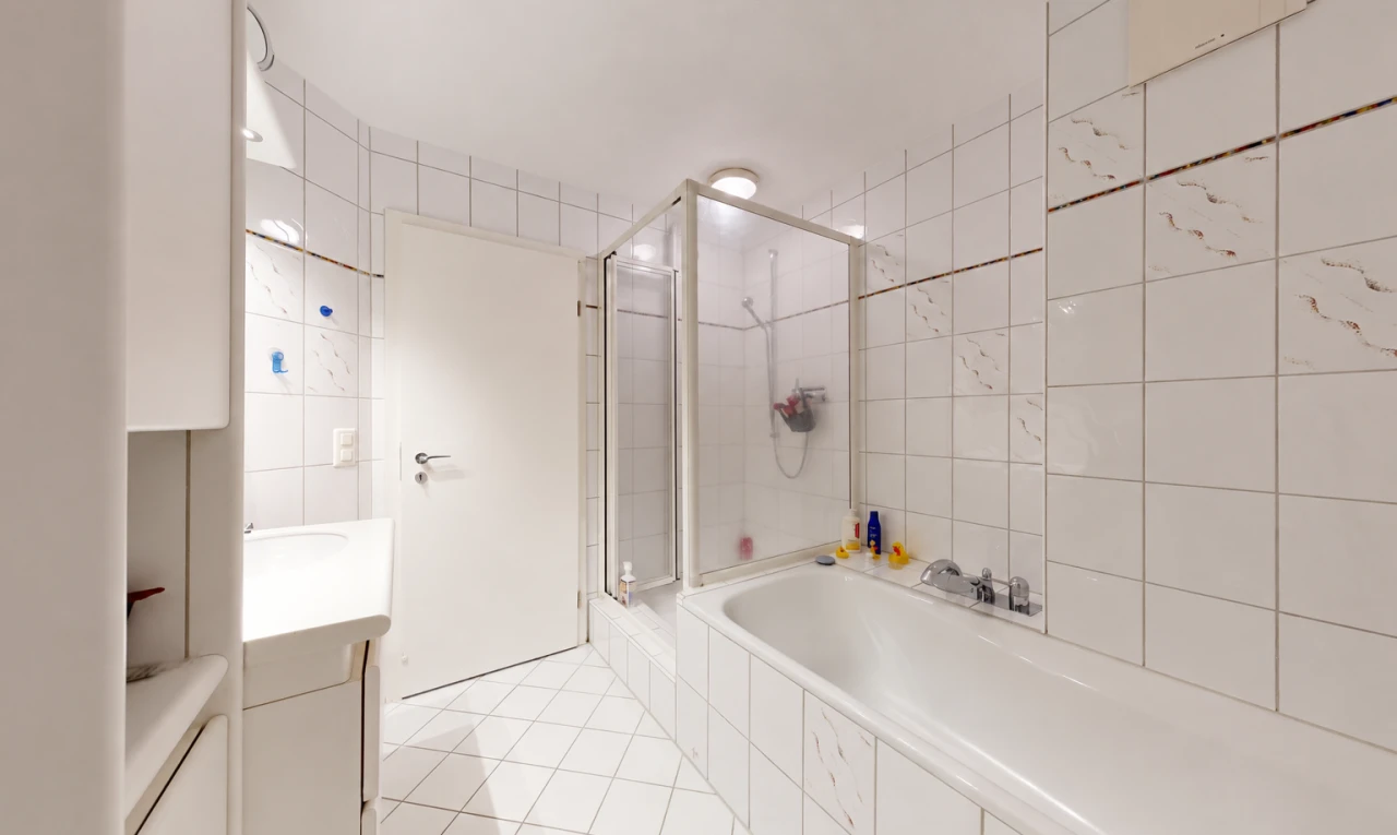 bathroom featuring a shower stall, tile walls, vanity, a bath, and light tile patterned floors