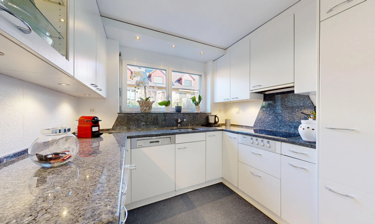 kitchen featuring dark stone counters, white cabinets, white dishwasher, and recessed lighting
