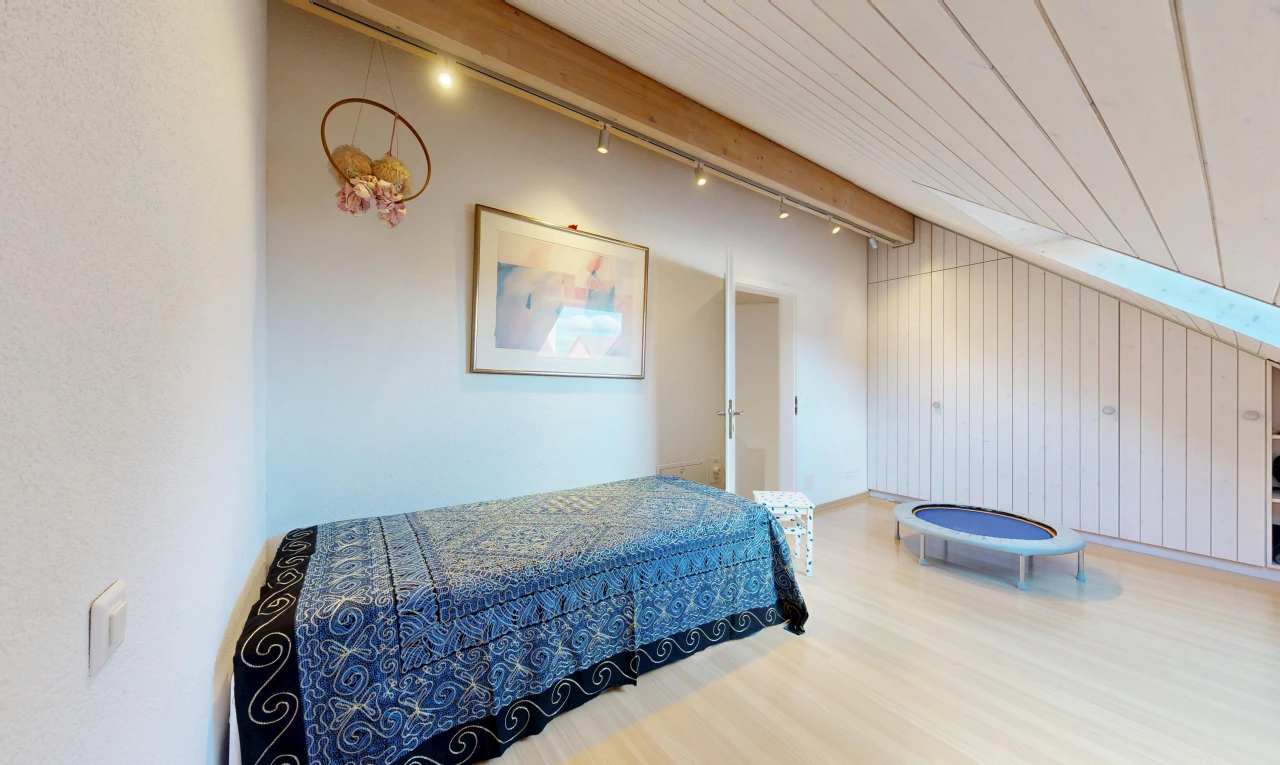 room / bedroom with light wood finished floors, wood walls, and track lighting