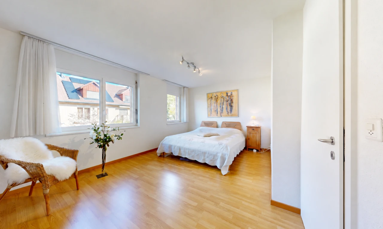 room / bedroom with light wood-style flooring and track lighting