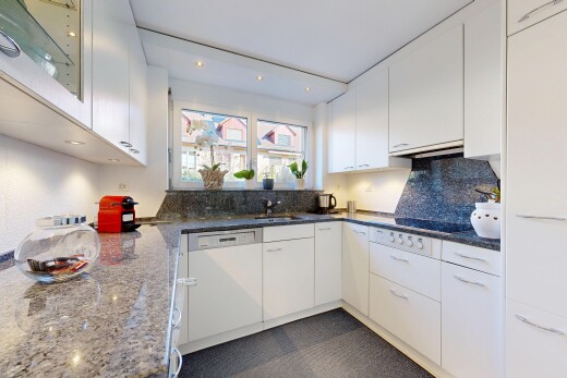 kitchen featuring dark stone counters, white cabinets, white dishwasher, and recessed lighting