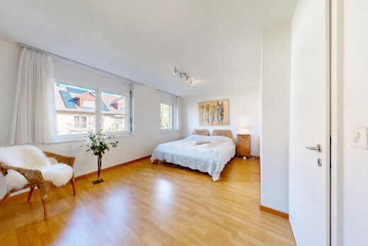 room / bedroom with light wood-style flooring and track lighting
