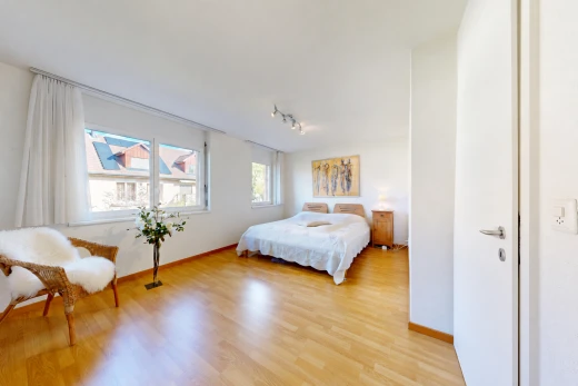 room / bedroom with light wood-style flooring and track lighting