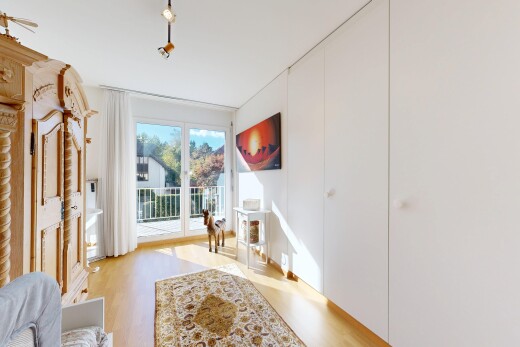 room with access to outside and light wood finished floors