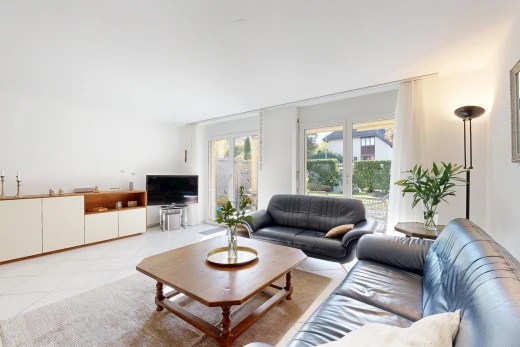 living room featuring access to exterior and light tile patterned floors