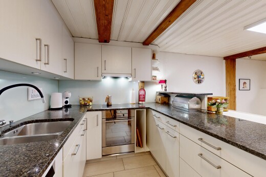 küche mit ofen, waschbecken, inside property, stein arbeitsplatten, und tile floor