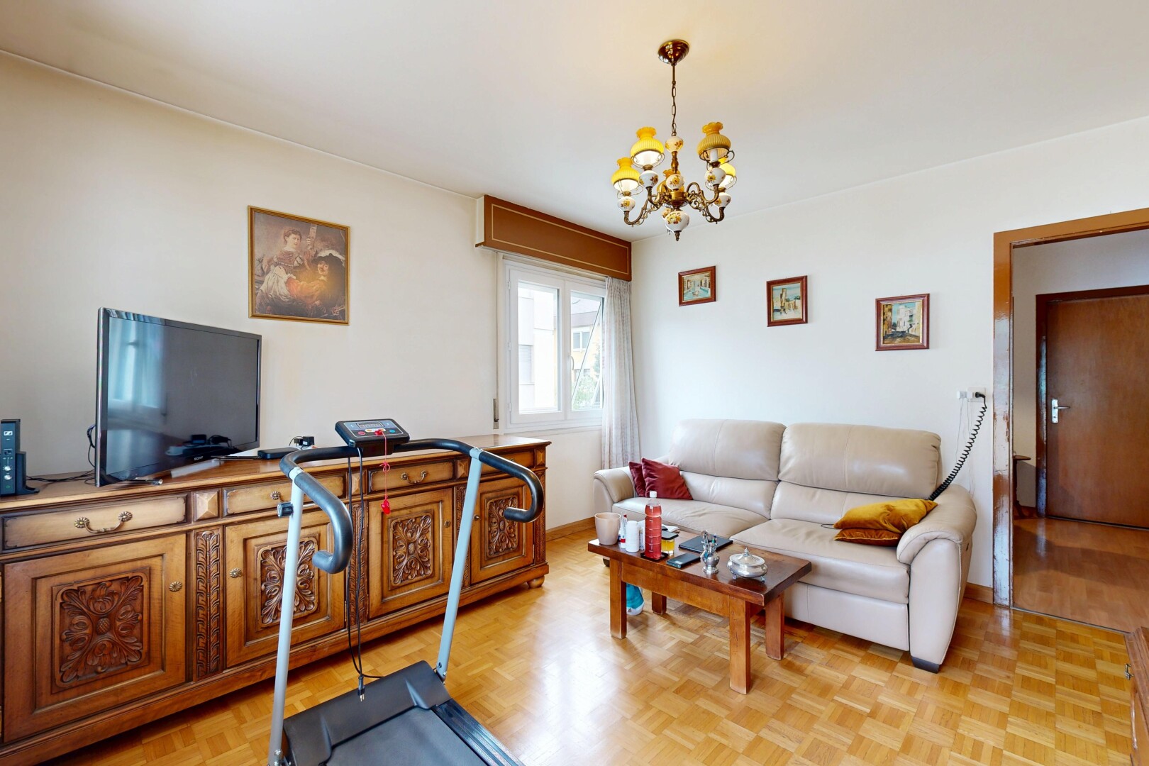 living area with parquet flooring and suspended lighting
