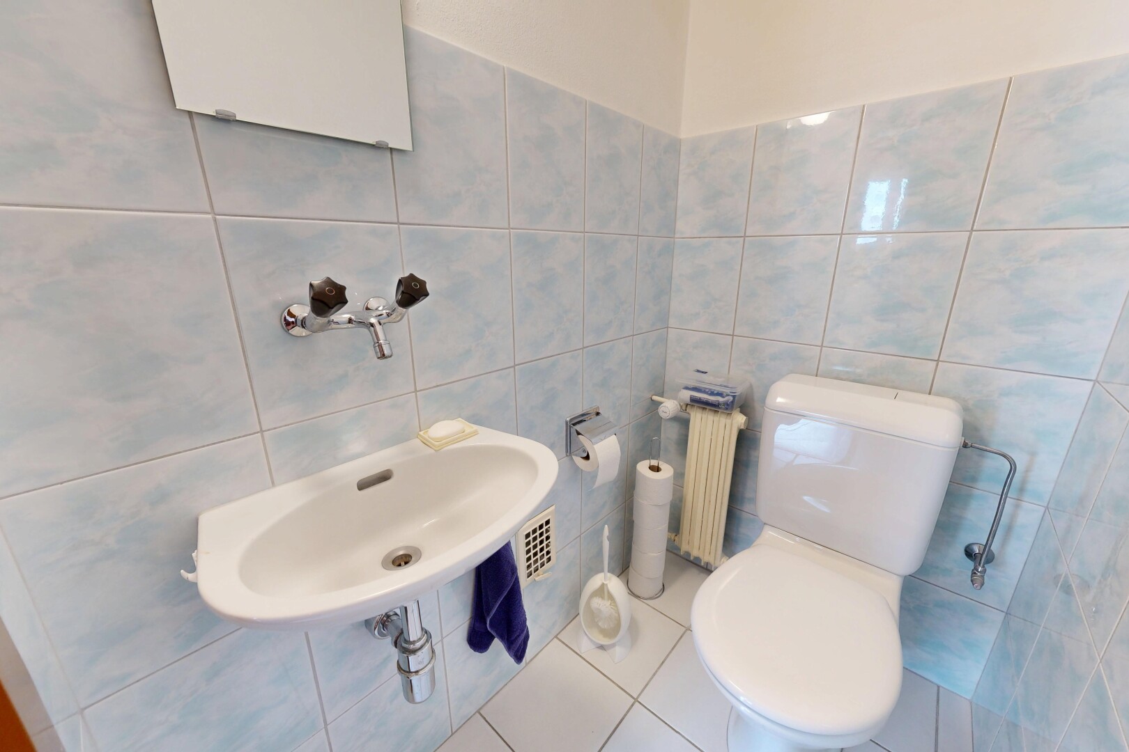 half bathroom featuring tile walls, radiator, and tile patterned flooring