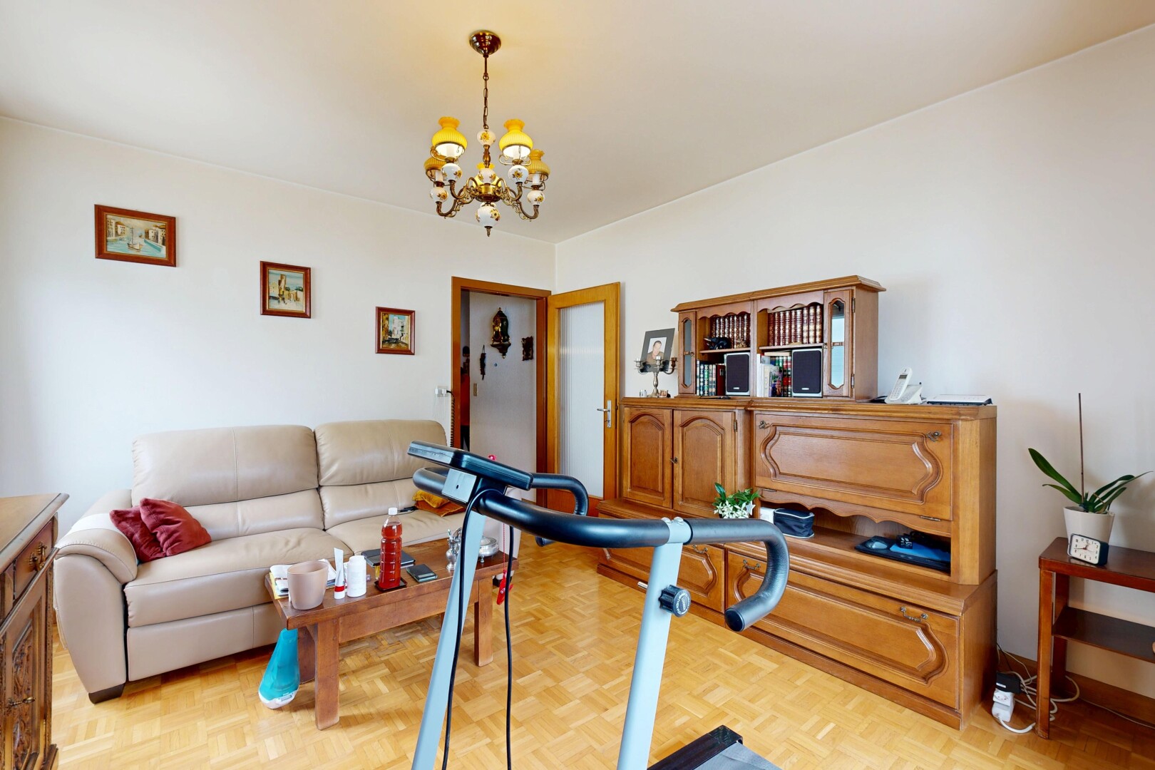 living room with parquet floors and a chandelier