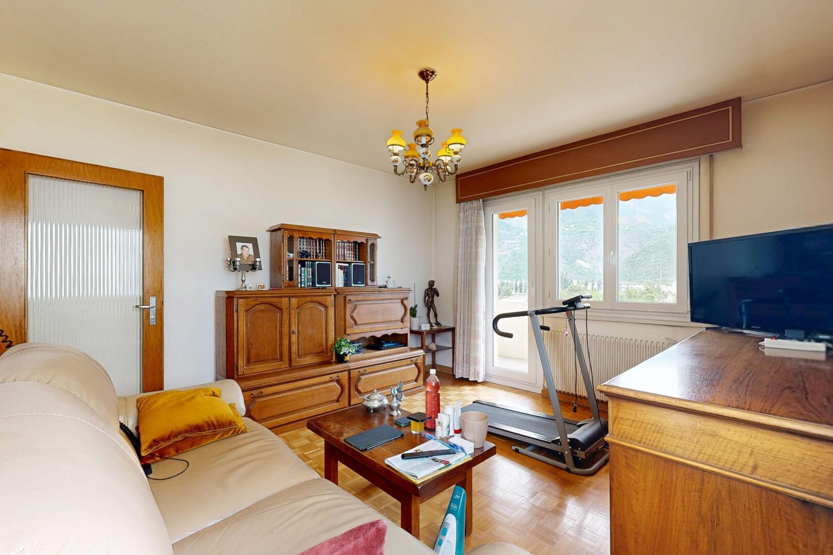 living area featuring hanging lights and parquet floors