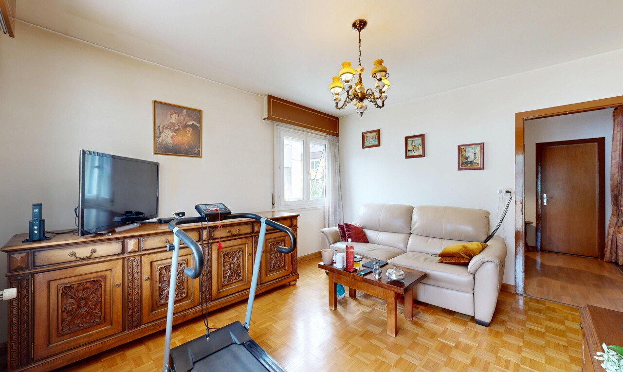 living area with parquet flooring and suspended lighting