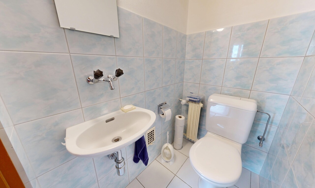 half bathroom featuring tile walls, radiator, and tile patterned flooring