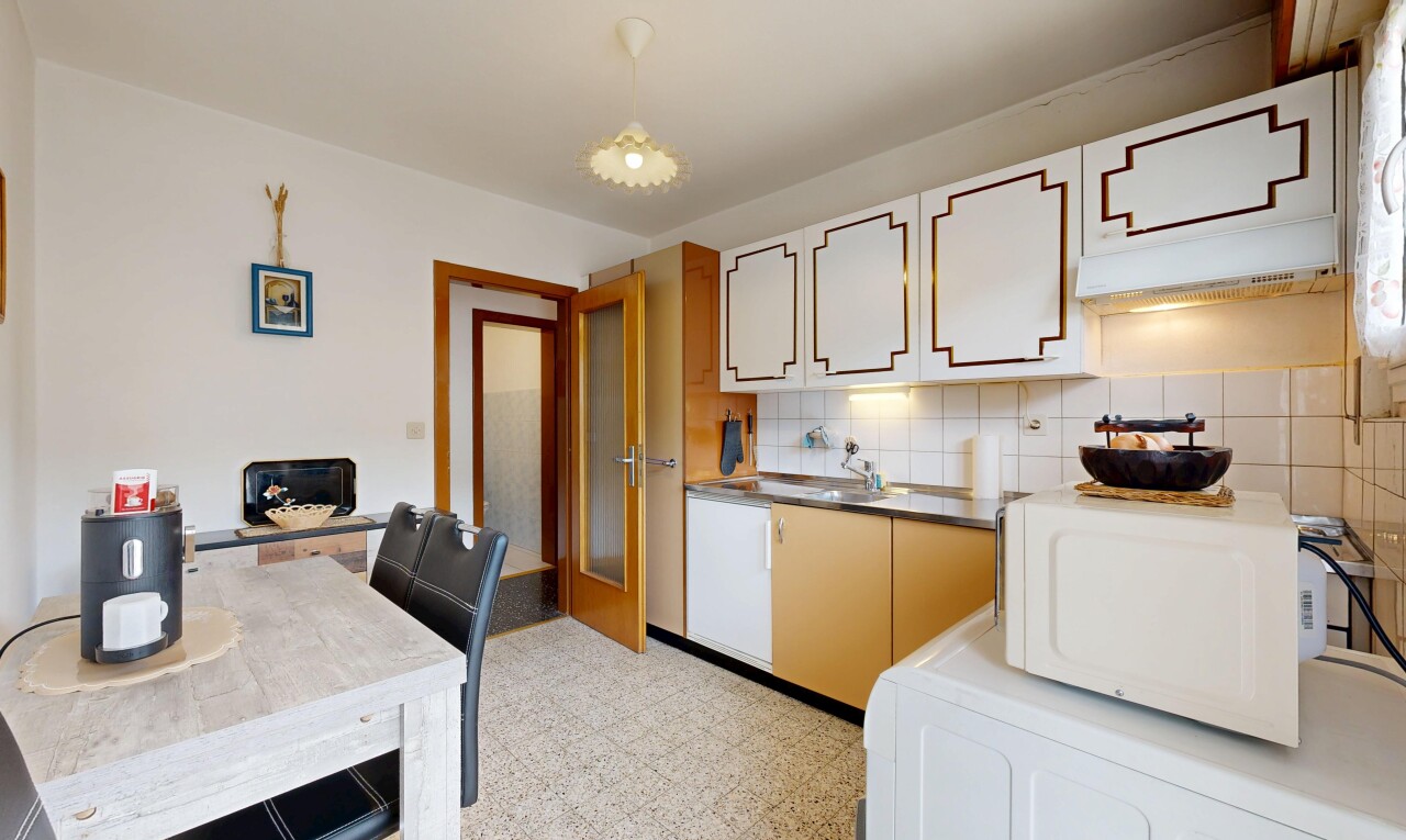 dual tone kitchen with white microwave, light floors, washer / dryer, tasteful backsplash, and dual tone cabinets