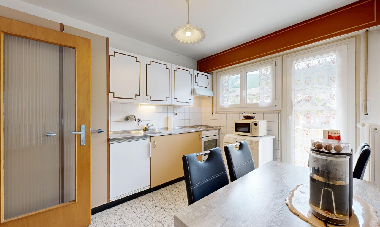 dual tone kitchen with light floors, light countertops, extractor fan, oven, and tasteful backsplash